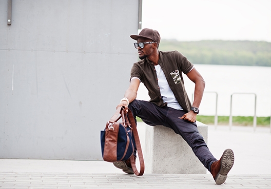 Man sitting at the airport with his backpack