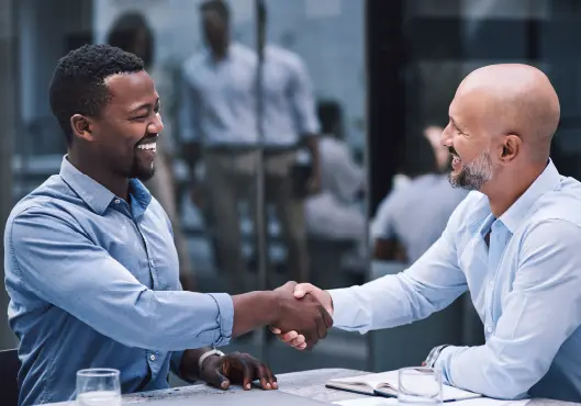 businessmen shaking hands during a meeting.