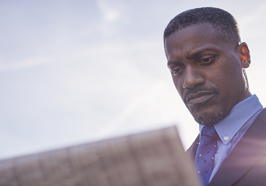 man looking at a newspaper