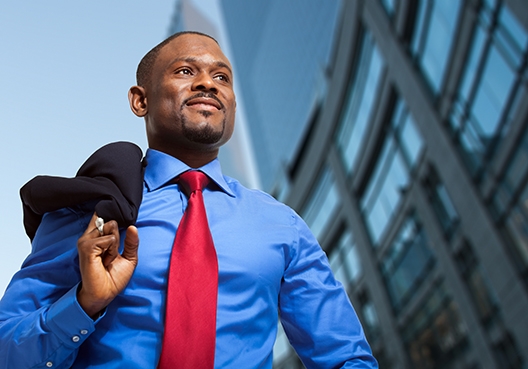 business walking outside office building