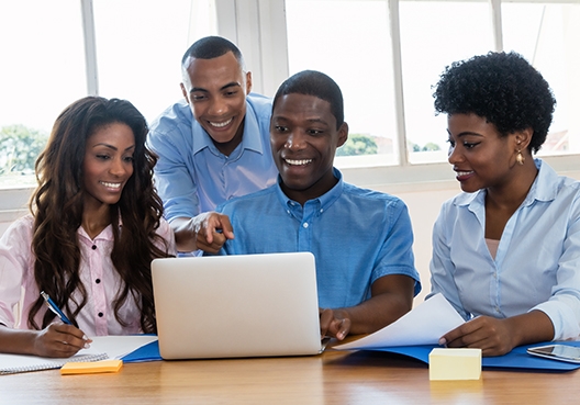 colleagues looking at a laptop