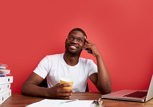 man sitting behind his desk in thought